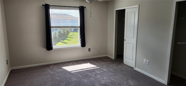 unfurnished bedroom featuring dark carpet