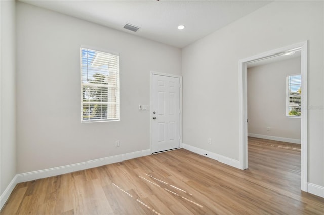 empty room with plenty of natural light and light wood-type flooring