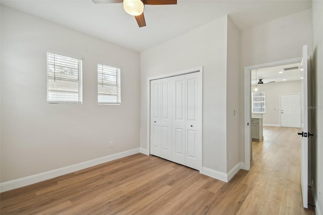 unfurnished bedroom with a closet, ceiling fan, and light hardwood / wood-style flooring