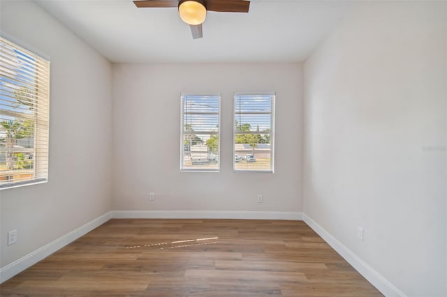 empty room featuring wood-type flooring and ceiling fan