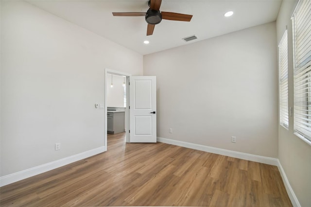 unfurnished bedroom featuring hardwood / wood-style flooring and ceiling fan