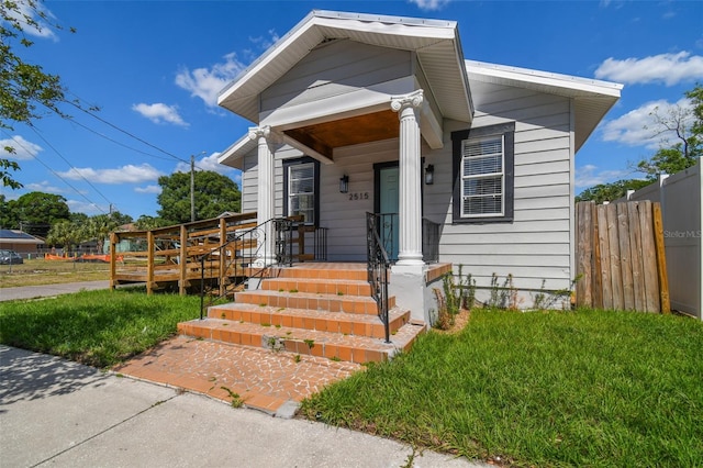 bungalow-style home with a front yard