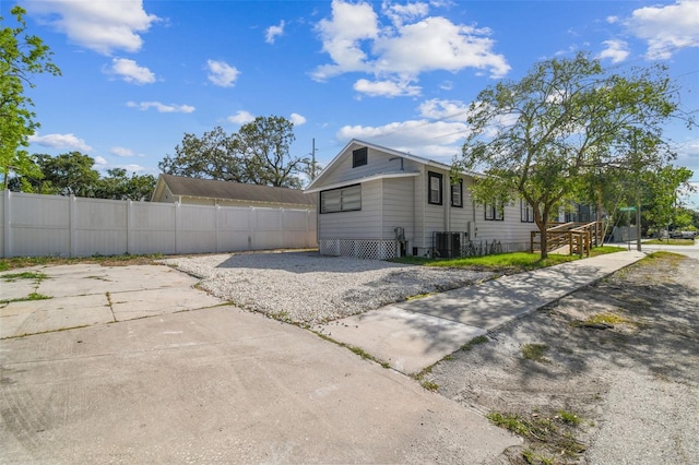 view of side of property featuring central AC