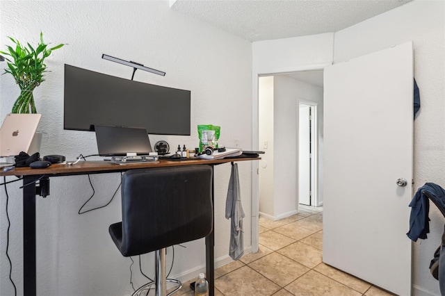 office area featuring light tile patterned floors and a textured ceiling