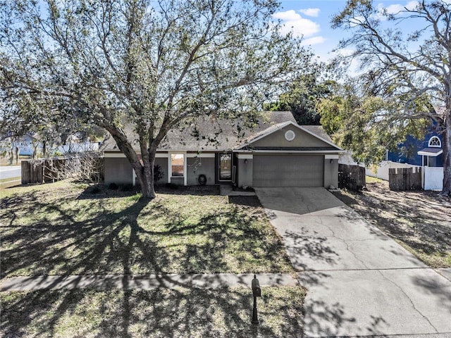 single story home featuring a garage and a front yard