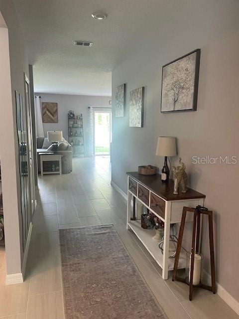 hallway with tile patterned flooring