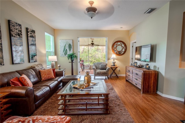 living room with hardwood / wood-style floors and ceiling fan