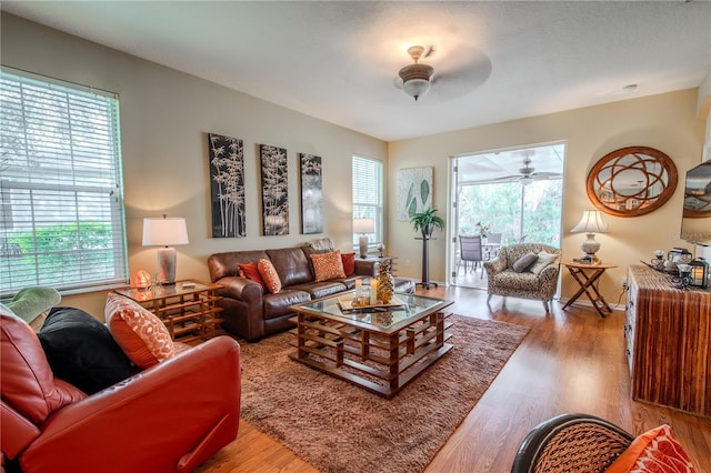 living room featuring ceiling fan and light hardwood / wood-style floors