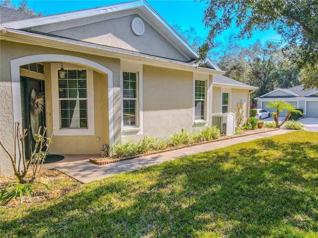 view of property exterior featuring central AC and a yard