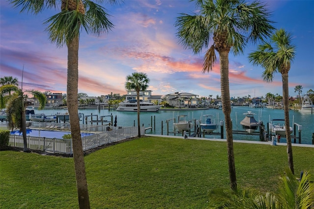 view of dock featuring a water view and a lawn