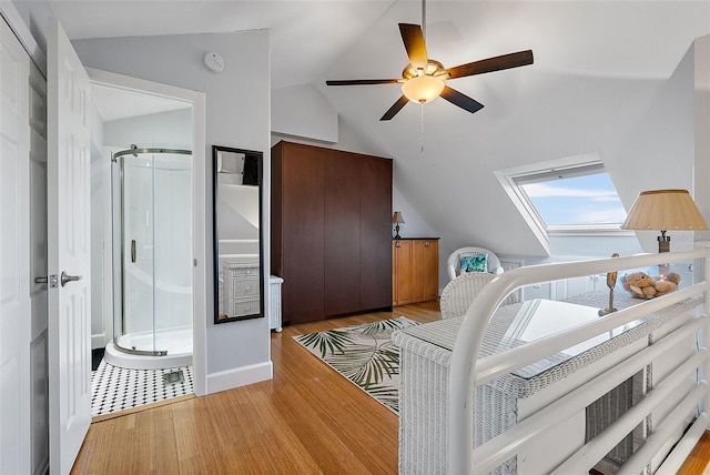 bedroom featuring ceiling fan, lofted ceiling, and light hardwood / wood-style floors