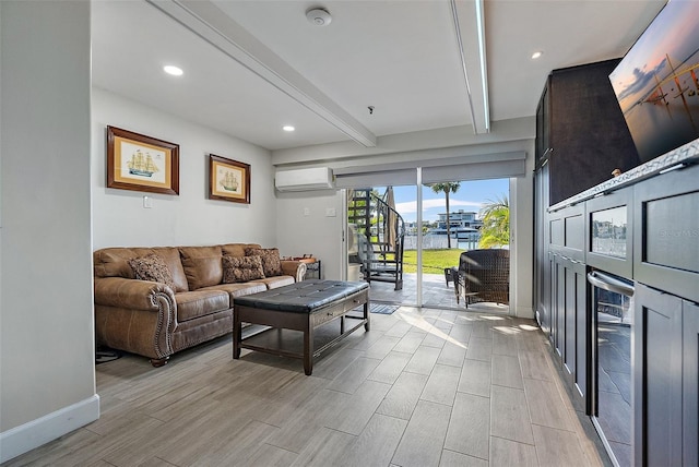 living room with beam ceiling and an AC wall unit