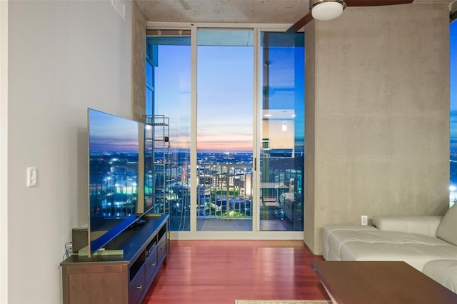 living room featuring expansive windows and hardwood / wood-style flooring