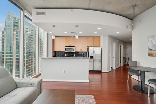 living room featuring dark hardwood / wood-style flooring and a wall of windows