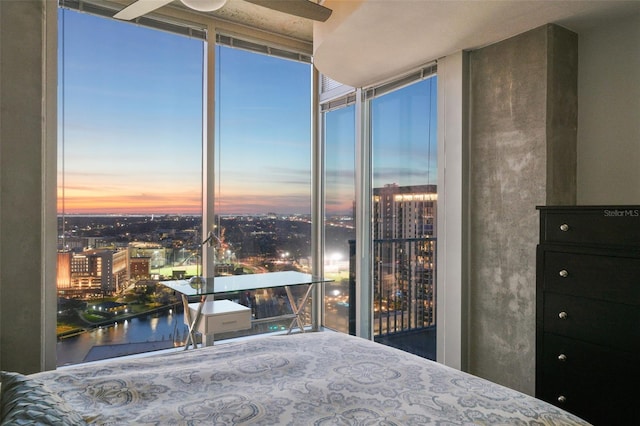 unfurnished bedroom featuring a water view and floor to ceiling windows