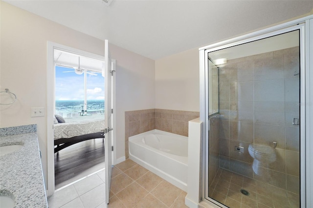 full bathroom featuring vanity, tile patterned floors, toilet, and separate shower and tub