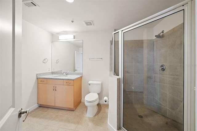 bathroom featuring a shower with door, vanity, tile patterned flooring, and toilet