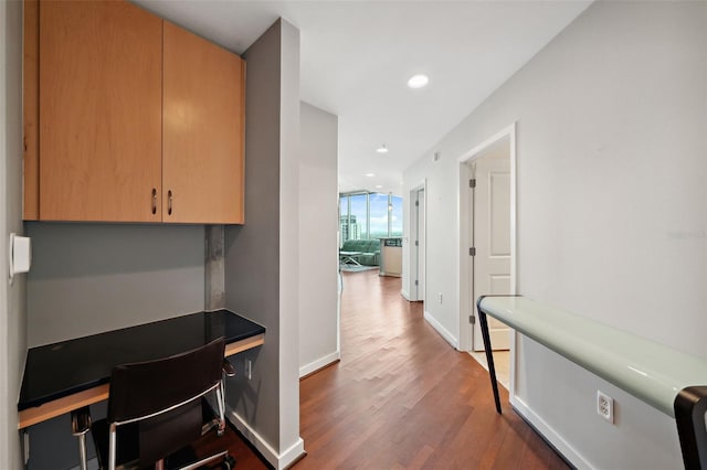 hallway with hardwood / wood-style floors