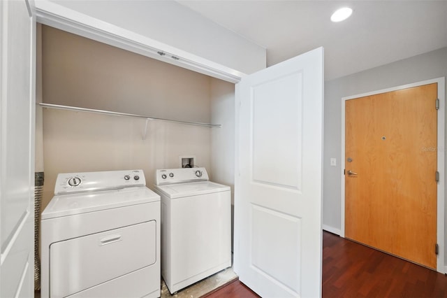 laundry room featuring dark hardwood / wood-style flooring and washing machine and dryer