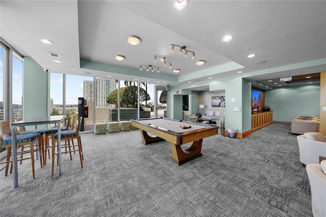 recreation room with a raised ceiling, carpet floors, pool table, and a wall of windows