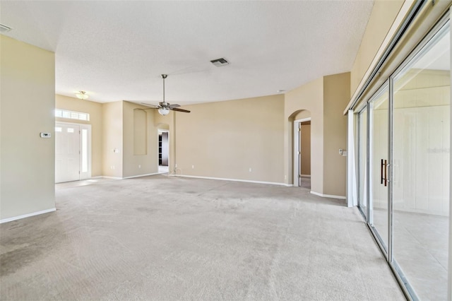 carpeted spare room with ceiling fan and a textured ceiling