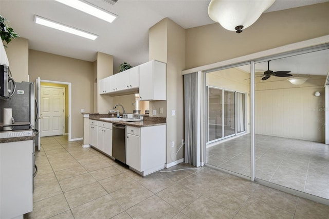 kitchen with white cabinetry, appliances with stainless steel finishes, vaulted ceiling, and sink