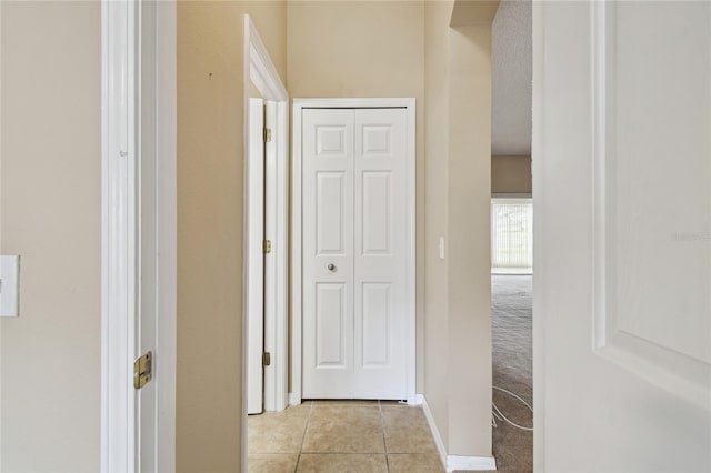 hall with light tile patterned floors