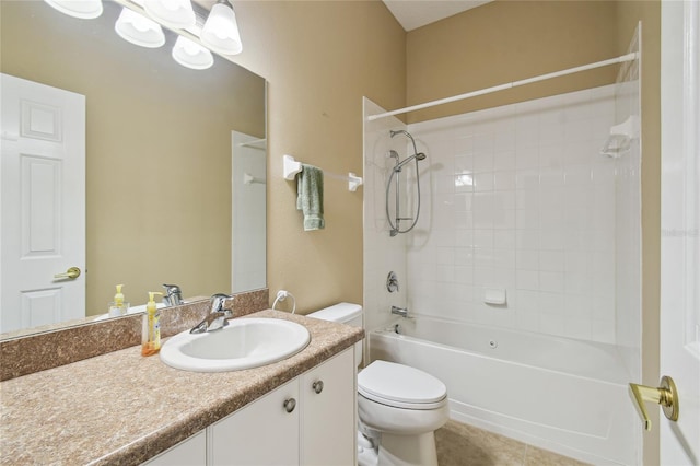 full bathroom featuring tile patterned flooring, vanity, tiled shower / bath, and toilet