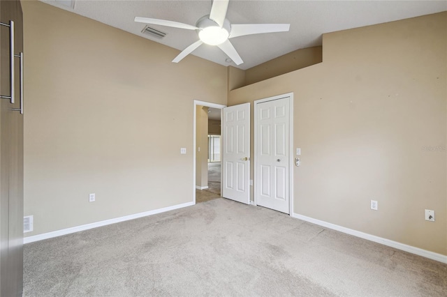 unfurnished bedroom with light carpet, ceiling fan, and a closet