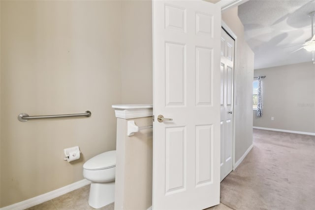 bathroom featuring tile patterned floors, ceiling fan, and toilet