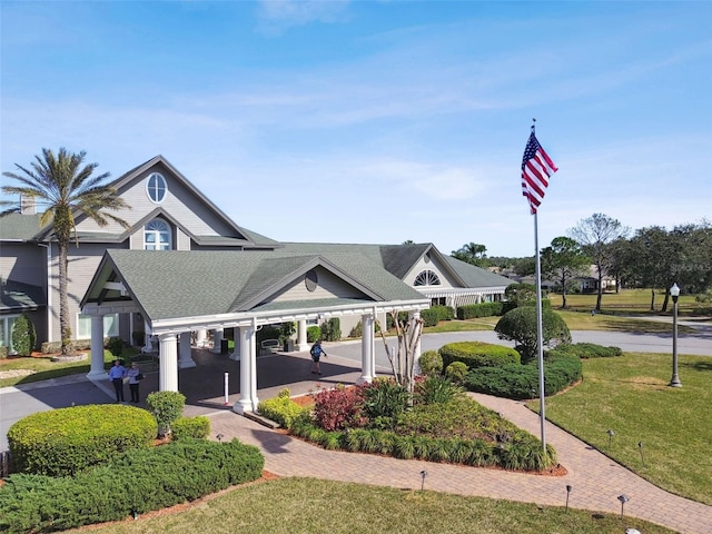 view of home's community featuring a lawn