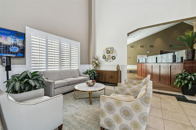 tiled living room with high vaulted ceiling