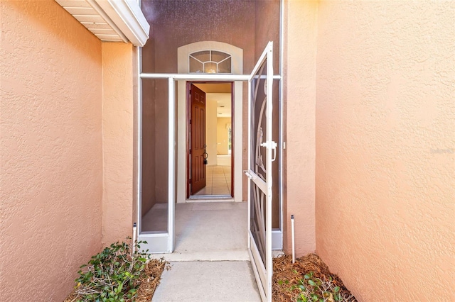 doorway to property with stucco siding