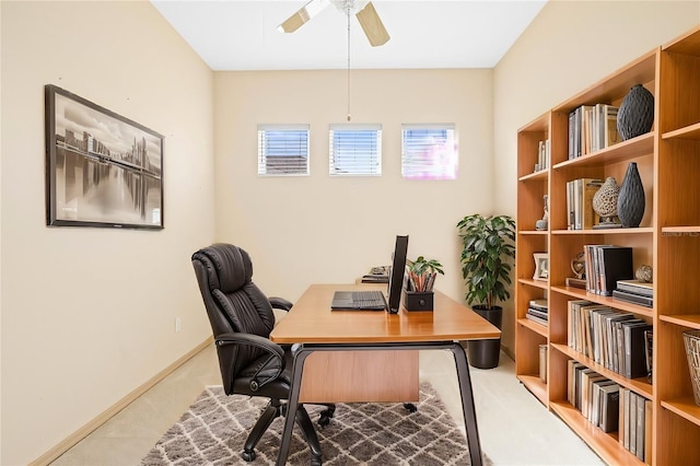 office space with ceiling fan and baseboards