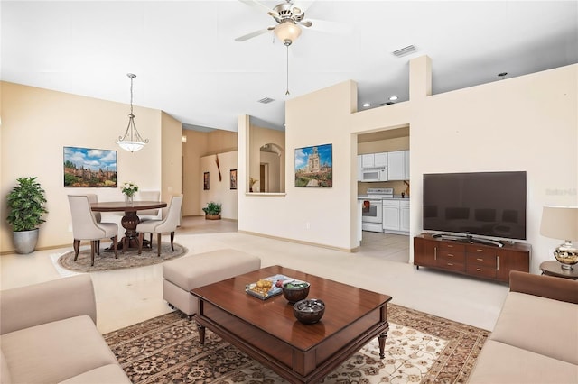 living room with visible vents and a ceiling fan