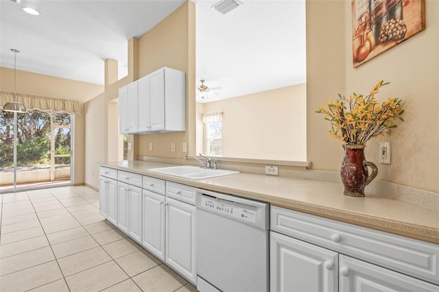 kitchen with a wealth of natural light, visible vents, light tile patterned flooring, white dishwasher, and a sink