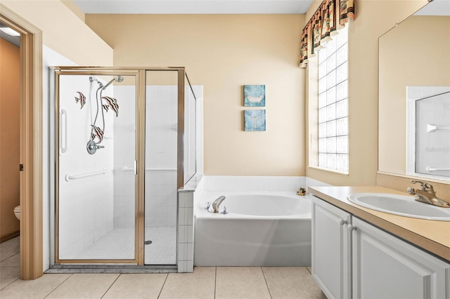 full bath with tile patterned floors, toilet, vanity, a shower stall, and a bath