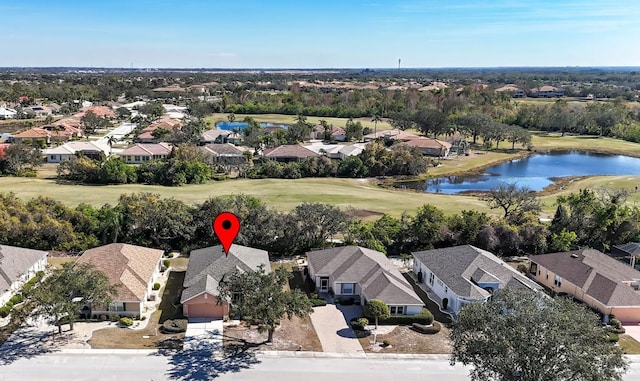 drone / aerial view featuring a residential view, a water view, and golf course view