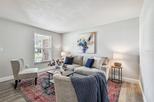 living room featuring hardwood / wood-style floors and a textured ceiling