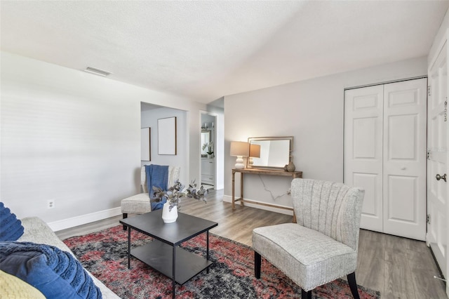 living room featuring hardwood / wood-style flooring and a textured ceiling