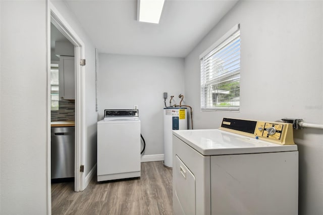 laundry room with hardwood / wood-style floors, washer and clothes dryer, and electric water heater