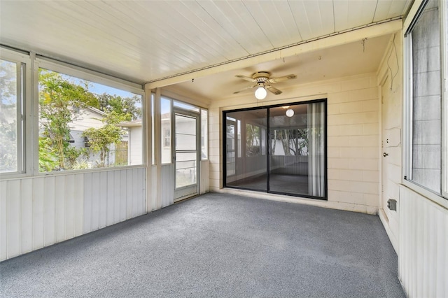 unfurnished sunroom featuring ceiling fan