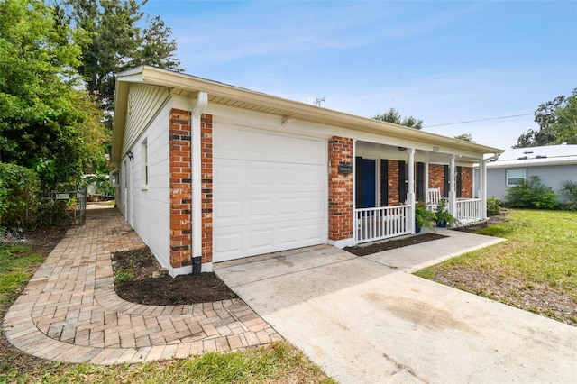 single story home with a garage, a front lawn, and covered porch