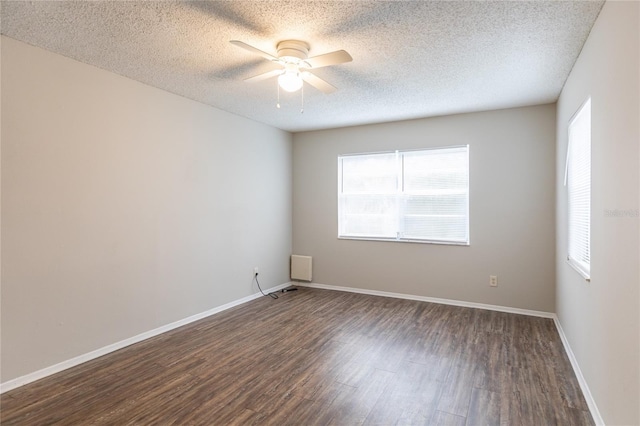 spare room featuring a textured ceiling, dark wood-type flooring, and ceiling fan