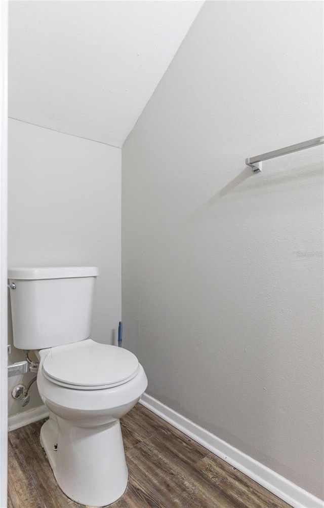 bathroom with hardwood / wood-style flooring and toilet