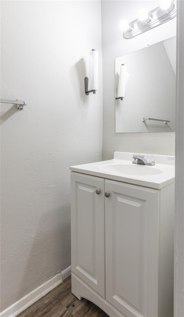 bathroom with vanity and hardwood / wood-style floors