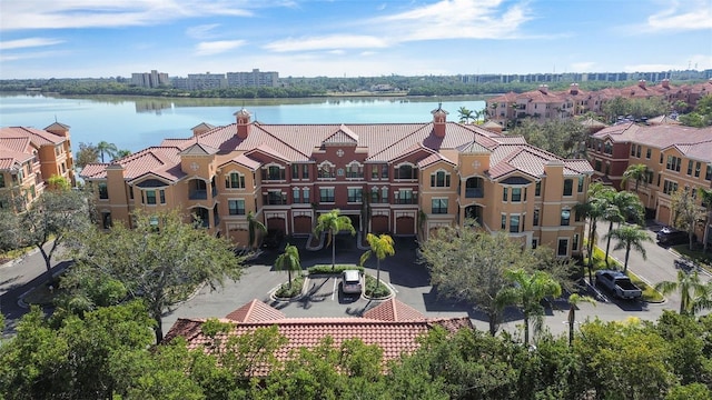 drone / aerial view featuring a water view and a residential view