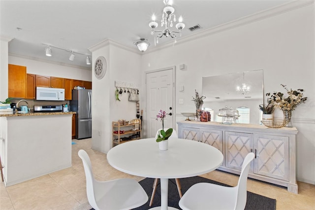 dining space with visible vents, ornamental molding, a notable chandelier, and light tile patterned flooring