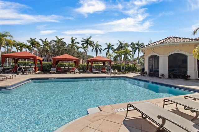 pool with a patio and a gazebo