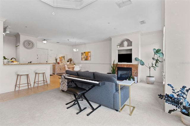 living area with light carpet, crown molding, and visible vents